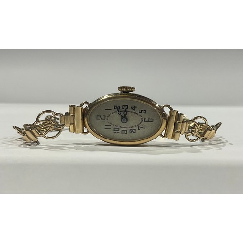 272 - A lady's 9ct gold watch, the oval engine turned dial with Arabic numerals, the case marked 375, gold... 