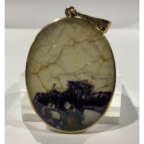 276 - A 9ct gold mounted Derbyshire Blue John oval pendant, marked 375, mother-of-pearl to verso, the pend... 