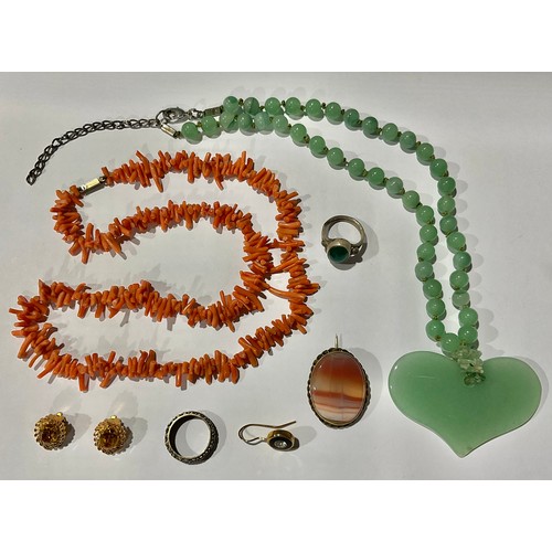 359 - A Chinese jade pendant necklace; a coral necklace; an eternity ring; etc