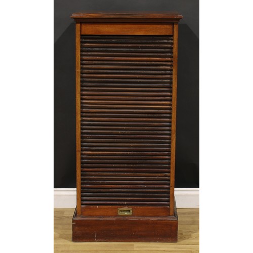 81 - An early 20th century mahogany tambour front pedestal cabinet, retractable door enclosing a single d... 