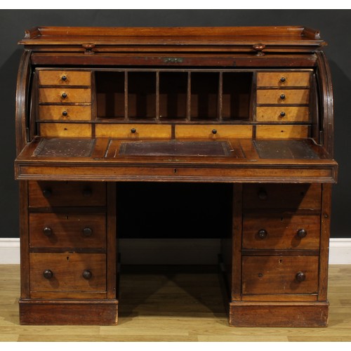 82 - A Victorian mahogany twin pedestal cylinder desk, retractable door enclosing a writing surface, smal... 