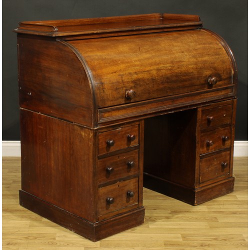 82 - A Victorian mahogany twin pedestal cylinder desk, retractable door enclosing a writing surface, smal... 