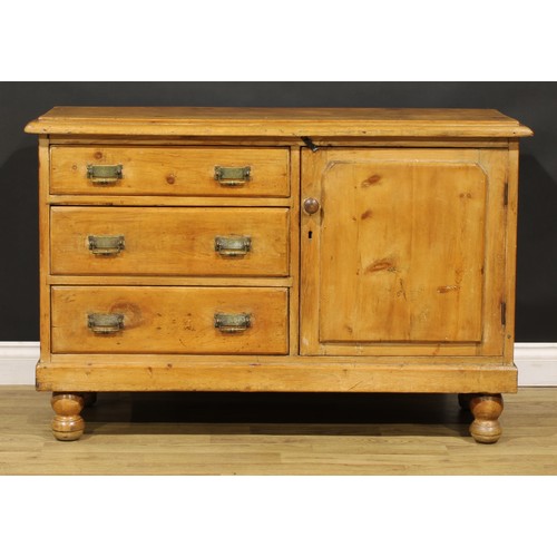 83 - A late Victorian farmhouse pine low dresser, oversailing top above three drawers neighboured by a pa... 