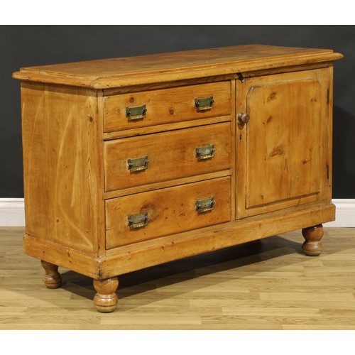 83 - A late Victorian farmhouse pine low dresser, oversailing top above three drawers neighboured by a pa... 