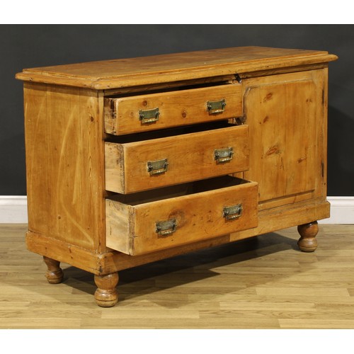 83 - A late Victorian farmhouse pine low dresser, oversailing top above three drawers neighboured by a pa... 