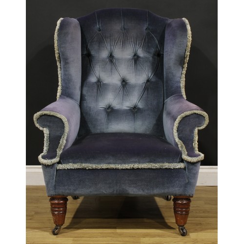 87 - A Victorian wing chair, turned forelegs, ceramic casters, 108cm high, 86cm wide, the seat 53cm wide ... 