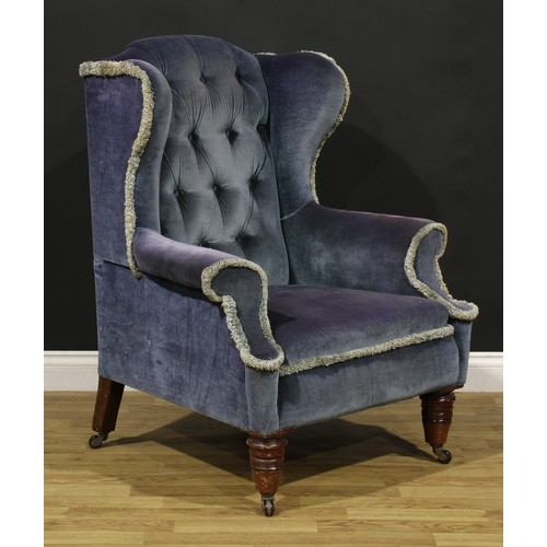 87 - A Victorian wing chair, turned forelegs, ceramic casters, 108cm high, 86cm wide, the seat 53cm wide ... 