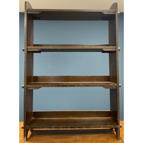 97 - A 1920s oak Arts and Crafts open bookcase, peg fixings, impressed numbers 1-34 to shelf facings, gab... 