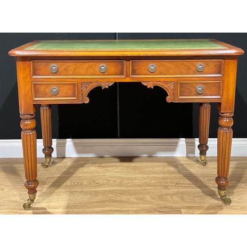 183 - A Victorian style writing desk, tooled and gilt writing surface, brass casters, 79cm high, 107cm wid... 