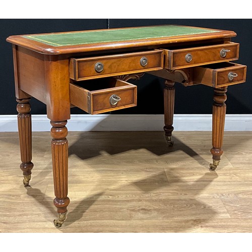 183 - A Victorian style writing desk, tooled and gilt writing surface, brass casters, 79cm high, 107cm wid... 