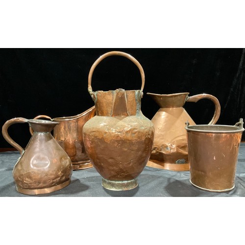 419 - A large Victorian copper ale jug, haystack form, 29cm high; another smaller; a 19th century planishe... 