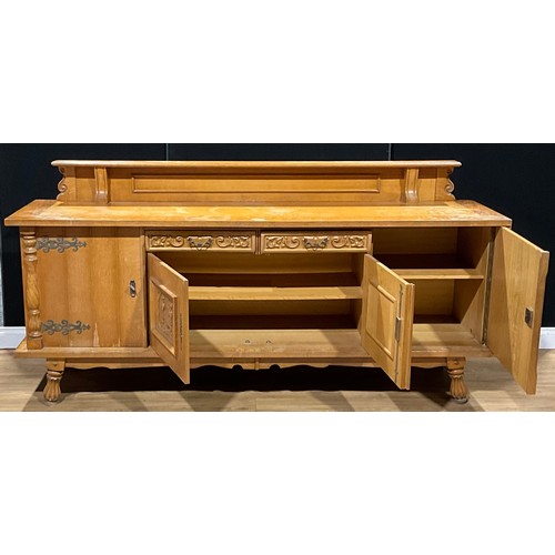 456 - A large Continental design oak buffet sideboard, the central door panels carved as 18th century styl... 