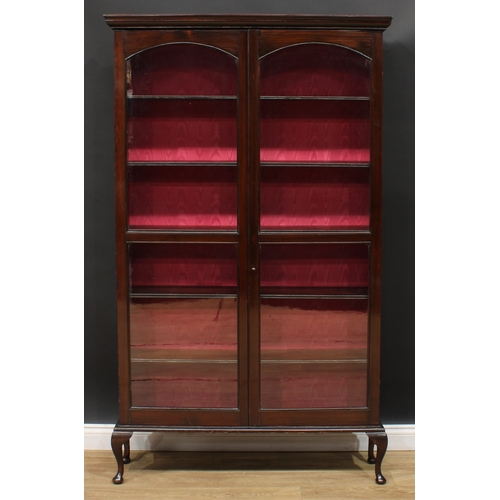 469 - An early 20th century display cabinet or bookcase, moulded cornice above a pair of glazed doors encl... 