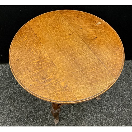 61 - An Arts and Crafts style oak occasional table, circular quarter-sawn oak top with reeded edge, serpe... 