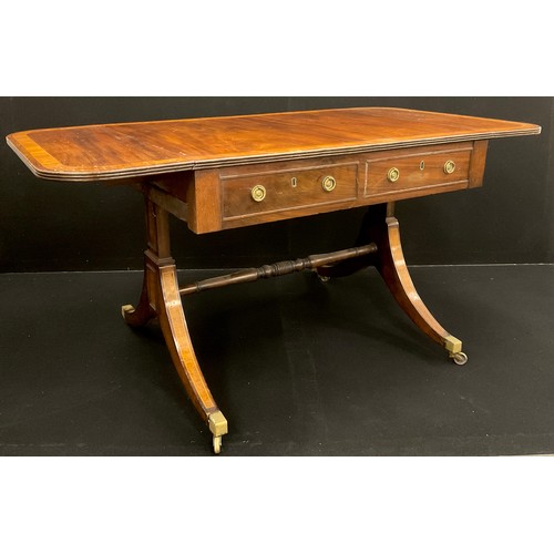 71 - A late 19th century mahogany sofa table; crossbanded rounded rectangular top, pair of drawers to fri... 