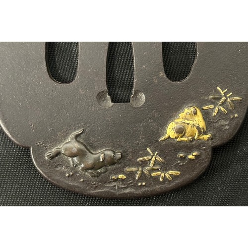 9089 - Japanese Sword Tsuba in bronze, unsigned, featuring two Dogs. Size 84mm x 77mm.