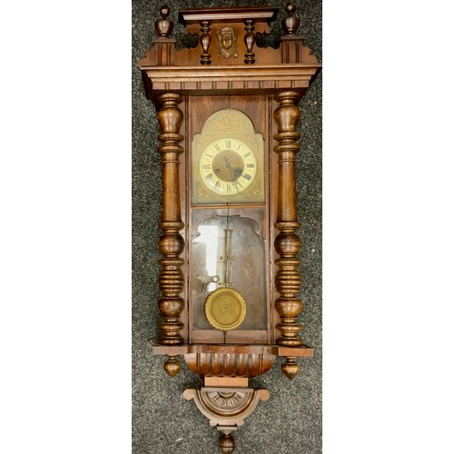 237 - A 20th century mahogany Vienna wall clock; enamel face, Roman numerals, includes pendulum and key.