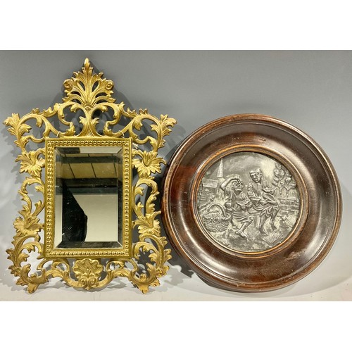 162 - A small Victorian gilt bronze bevelled glass mirror; a circular plaque (2)