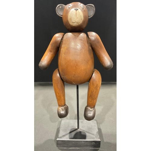 166 - A carved wooden teddy bear