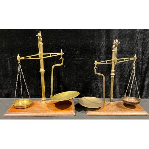 351 - A set of late 19th/early 20th century brass balance scales, rectangular mahogany base, 47cm high; an... 