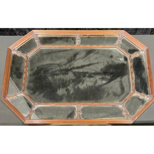 437 - An octagonal Art Nouveau period oak looking glass, bevelled mirror place, the outer panels divided b... 