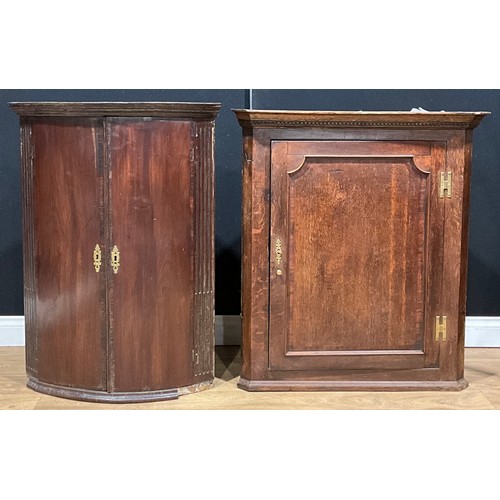 439 - A 19th century oak splay-front corner cabinet, 95.5cm high, 86cm wide, 47cm deep; another, mahogany,... 