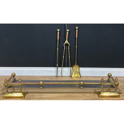 446 - A 19th century brass hearth suite, comprising fire curb or fender, irons and andirons, c.1890