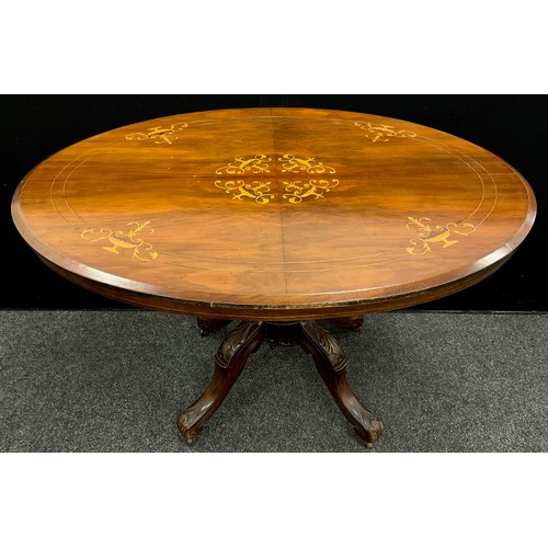 68 - A late 19th century walnut veneered Loo table, tilting oval top with boxwood inlay, carved pedestal ... 