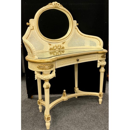 73 - A Louis XVI style dressing table, the oval tilting mirror supported by gracefully down-curved suppor... 