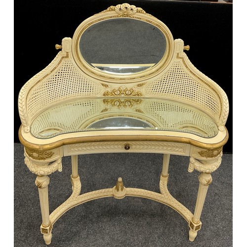 73 - A Louis XVI style dressing table, the oval tilting mirror supported by gracefully down-curved suppor... 