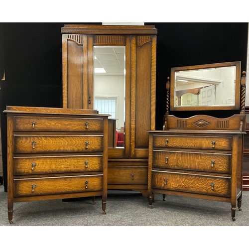 77 - A mid 20th century oak bedroom suite, comprised of single wardrobe, chest of four drawers, and dress... 