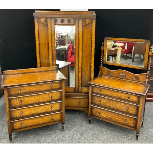 77 - A mid 20th century oak bedroom suite, comprised of single wardrobe, chest of four drawers, and dress... 