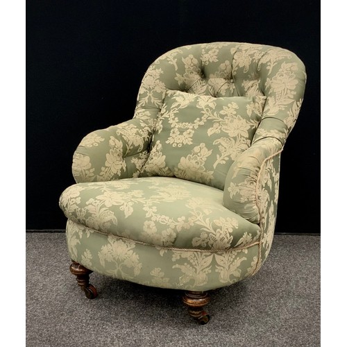 80 - An early 20th century button back armchair, floral embroidered pattern, turned front legs fitted wit... 