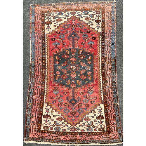 190 - A Persian, Hamadan style rug, hand-knotted in tones of red, blue, burgundy, and cream, 200cm x 122cm... 