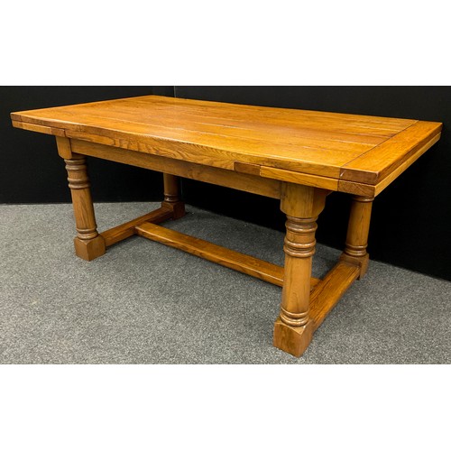 198 - An oak plank-top refectory dining table, by Brampton Furniture, extendable draw-leaves, turned colum... 