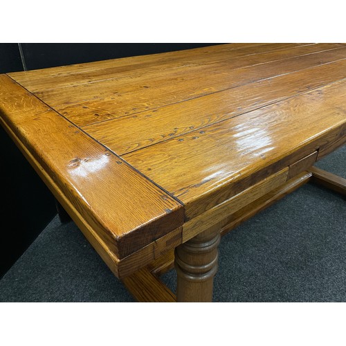 198 - An oak plank-top refectory dining table, by Brampton Furniture, extendable draw-leaves, turned colum... 