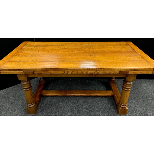 198 - An oak plank-top refectory dining table, by Brampton Furniture, extendable draw-leaves, turned colum... 