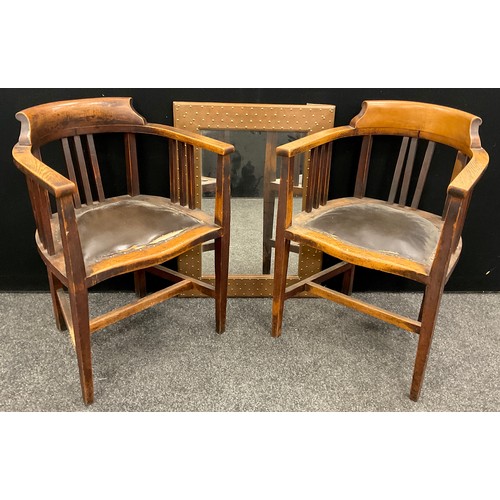 199 - A pair of early 20th century oak Smoker’s Bow armchairs, serpentine shaped fronts, leatherette padde... 