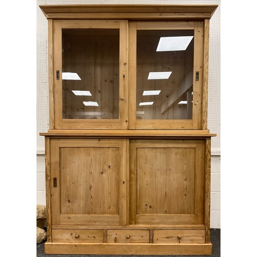 222 - A Pine Buffet Deux Corps, or glazed-top dresser, out-swept Cornice to top, over a pair of sliding gl... 