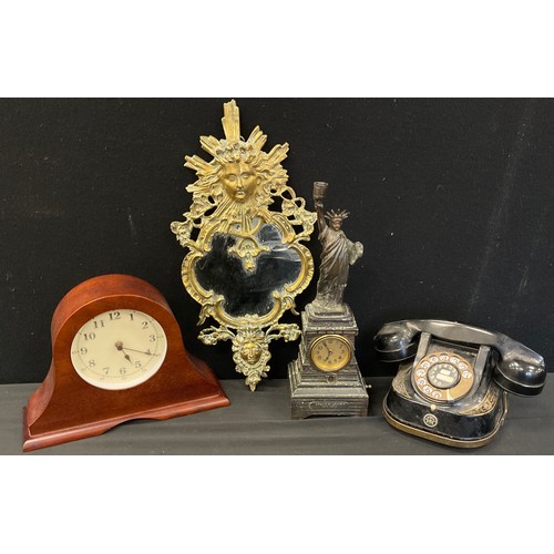 249 - A Statue of Liberty figural mantel clock, cream dial, bell telephone , brass framed mirror etc.