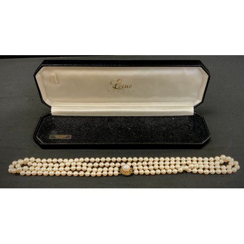 305 - A cultured pearl two strand necklace, silver gilt floral clasp, 54cm long, Lotus Royal box.