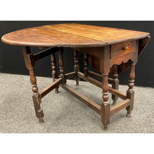 72A - A George III oak drop-leaf dining table, oval top, single drawer to frieze, 71cm high x 103cm x 43cm... 