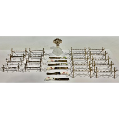 62 - A collection of nine Victorian silver plated pairs of knife rests; A set of six miniature knives, wi... 