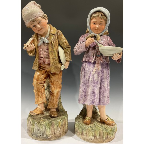 71 - A large pair of 19th century continental porcelain figures, as rural children, each 56cm high (2)