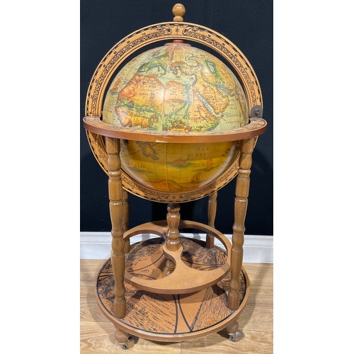 116 - A 20th century Italian style liquor cabinet in the form of a globe, standing on four turned wooden l... 