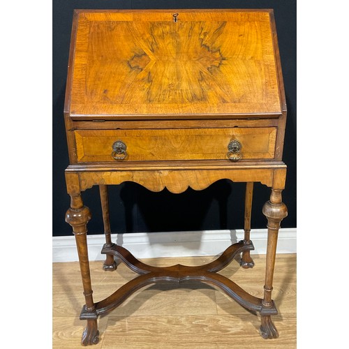 111 - A William and Mary style mahogany and walnut veneered bureau on stand, fall front, cross banded and ... 