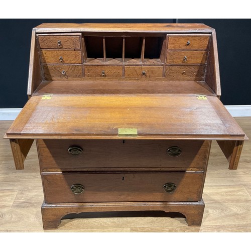 625 - A George III oak bureau, fall front enclosing small drawers and pigeonholes, above three long drawer... 