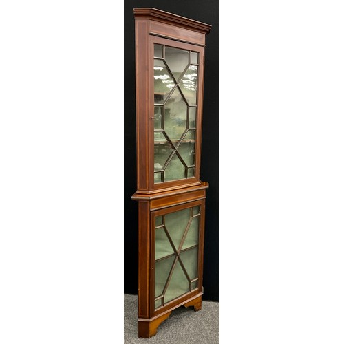 22 - An Edwardian Sheraton revival, satinwood cross-banded, mahogany corner cabinet, the astral-glazed do... 