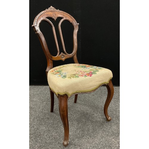 64 - A Victorian carved walnut ‘Chinoiserie’ style wing-back armchair, carved top rail, scroll arms, cabr... 