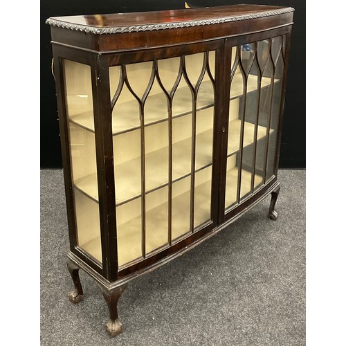 70 - An Edwardian mahogany bow-front display cabinet, glazed doors and sides enclosing three tiers of she... 